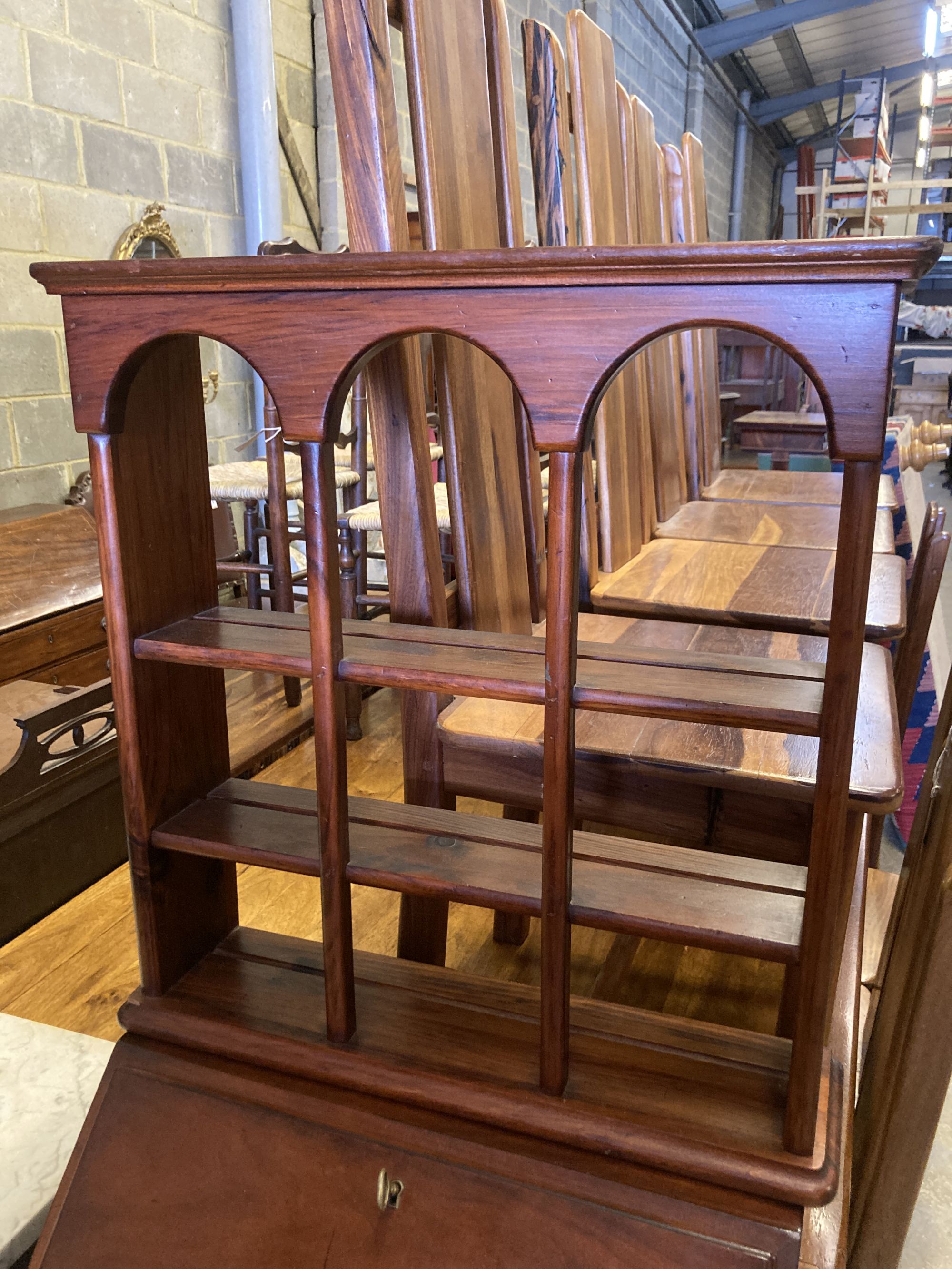 A small reproduction mahogany bureau, width 55cm, depth 43cm, height 102cm together with a three tier wall bracket